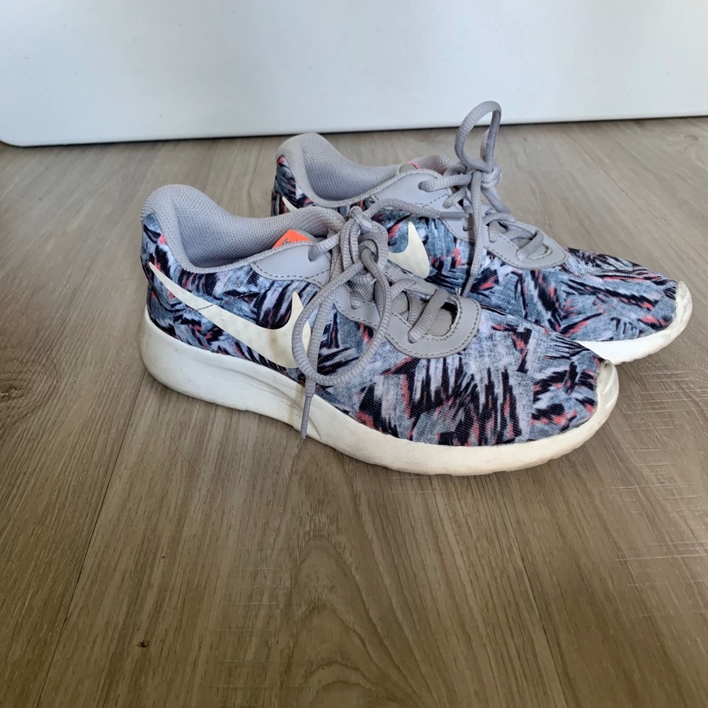 Grey patterned Nike running shoes